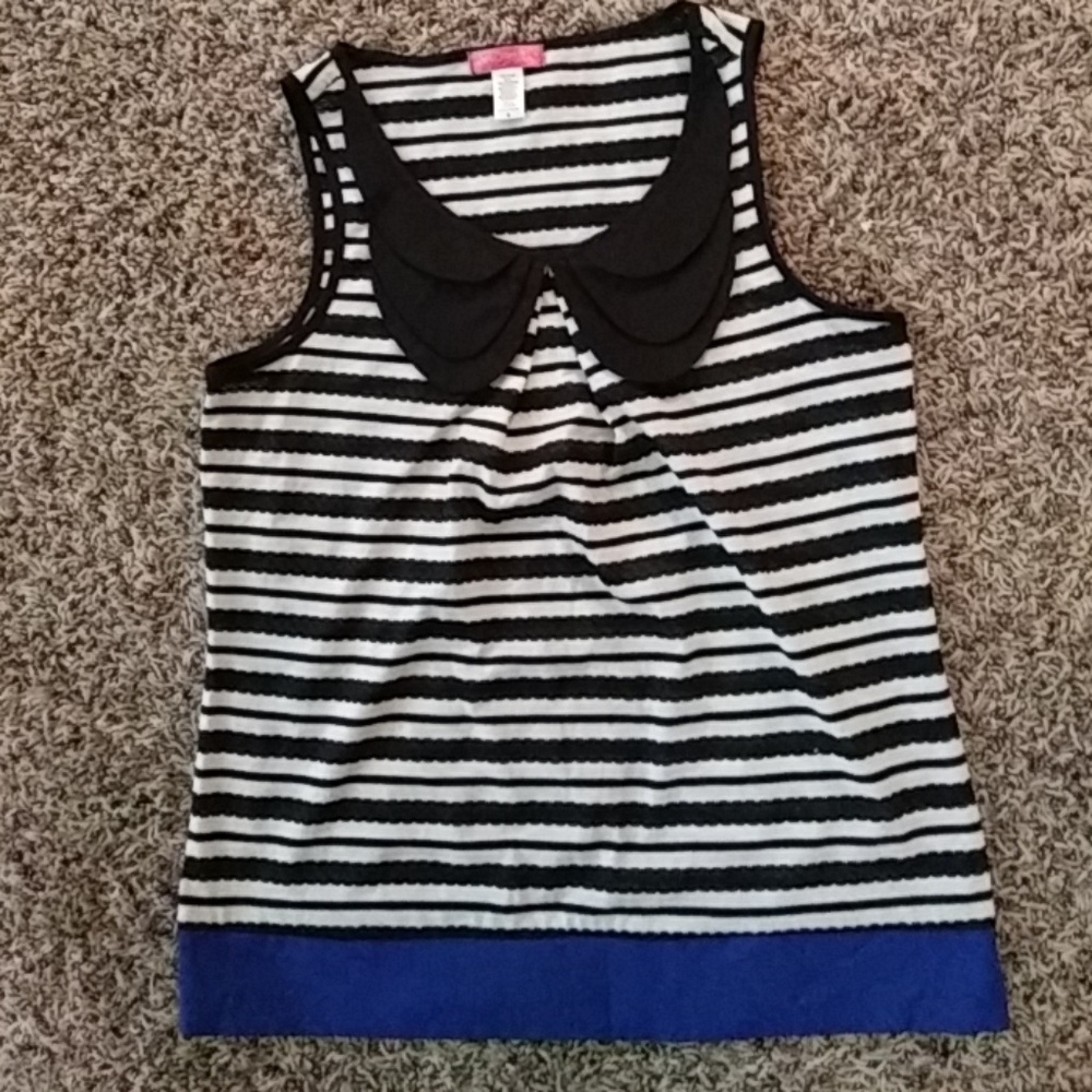 Black and white sleeveless top with ruffled neck